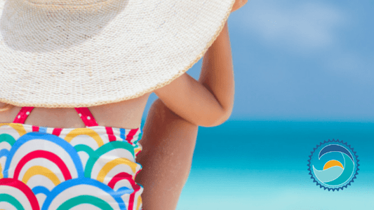 Sunscreen bans - girl in beach hat on beach