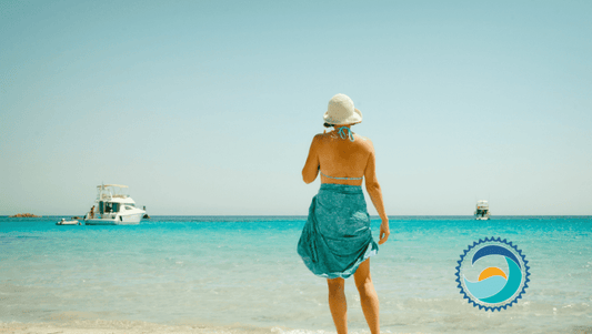 Person on beach using reef-safe sunscreen