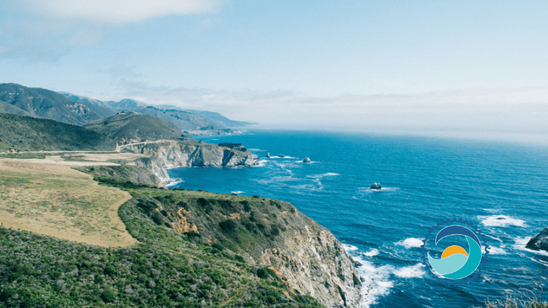 photo of ocean with mountains