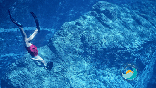 person freediving in ocean